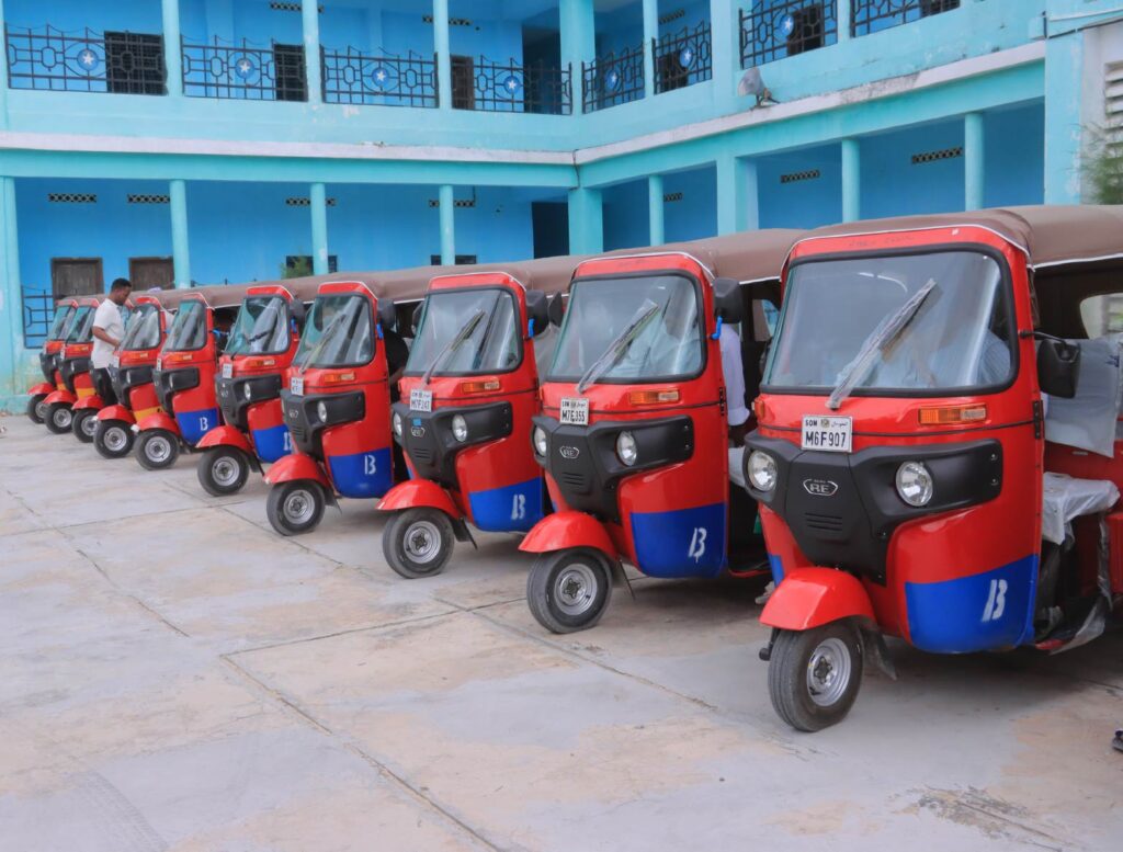 Red tuk-tuks provided through Kafi for Development's youth economic empowerment initiative in Mogadishu.